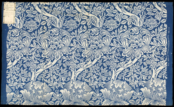 Intricate blue and white botanical blockprint pattern on fabric