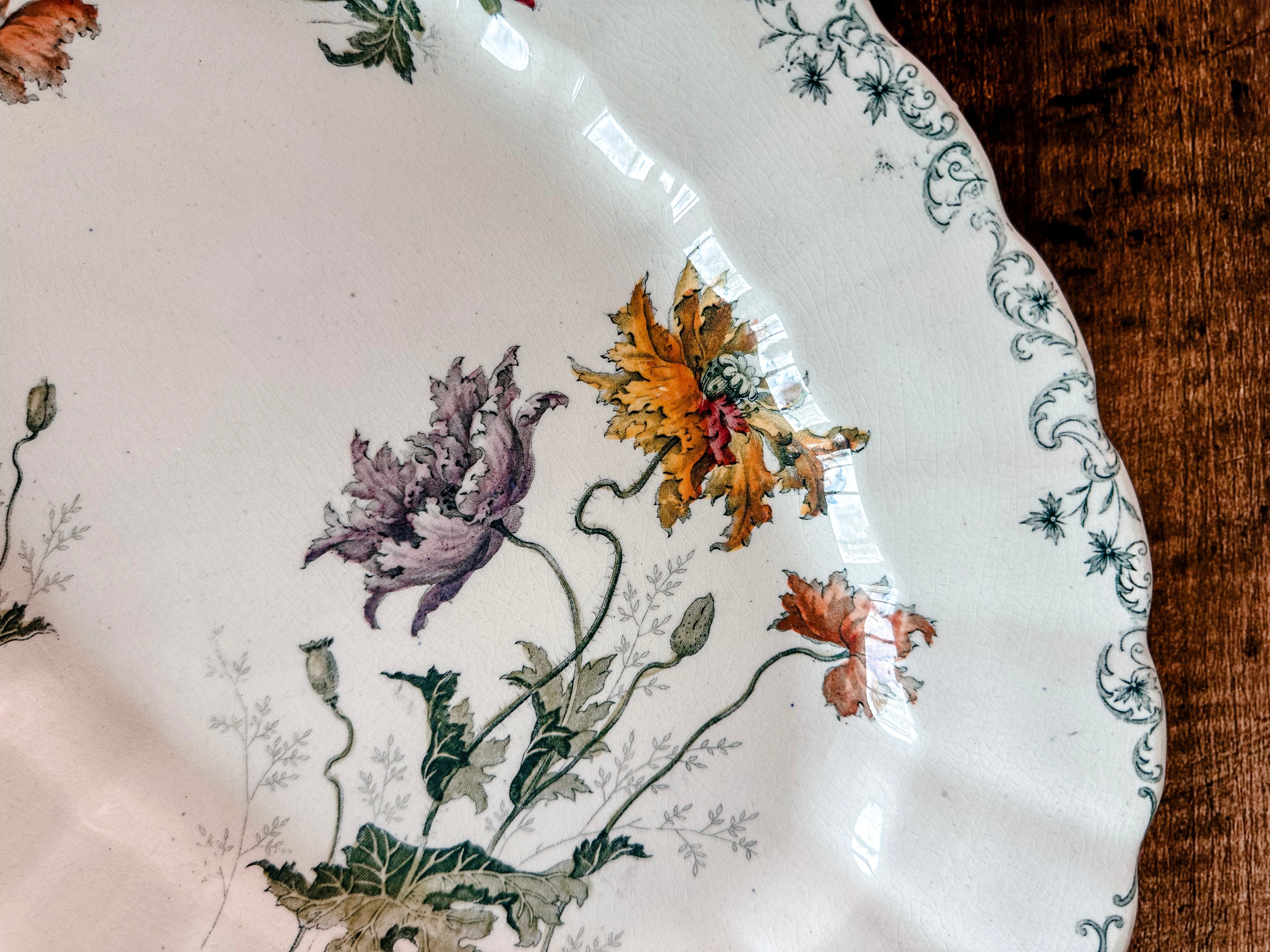 Closeup of Choisy-le-roi transferware platter with colorful purple and yellow floral motif 