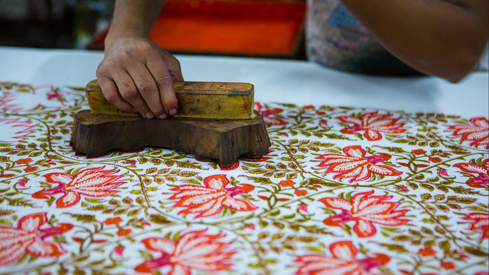 Intricate blue and white botanical blockprint pattern on fabric