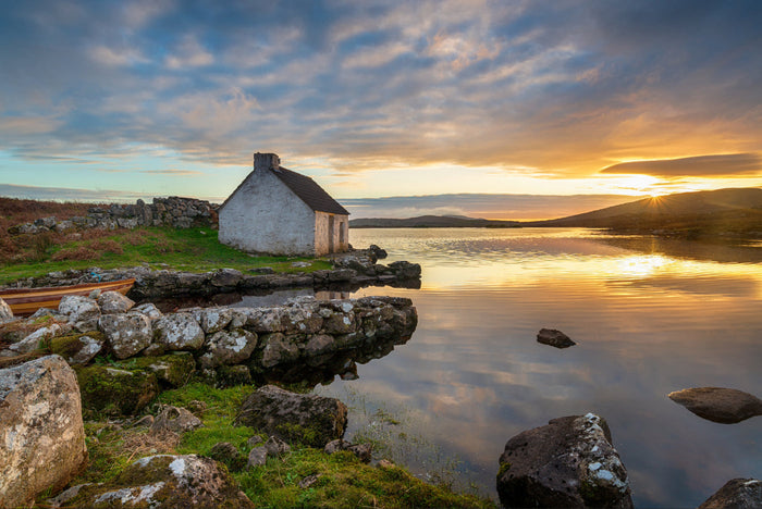 Stone single story seaside cottage with lichen  on roof
