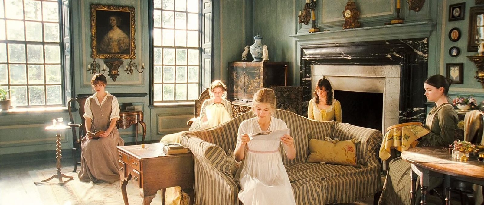Scene from Pride and Prejudice with Keira Knightley as Elizabeth Bennet seated by a fireplace in a library setting.