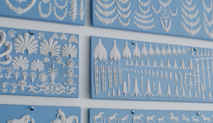 Closeup of light blue and white wedgewood jasperware neoclassical designs