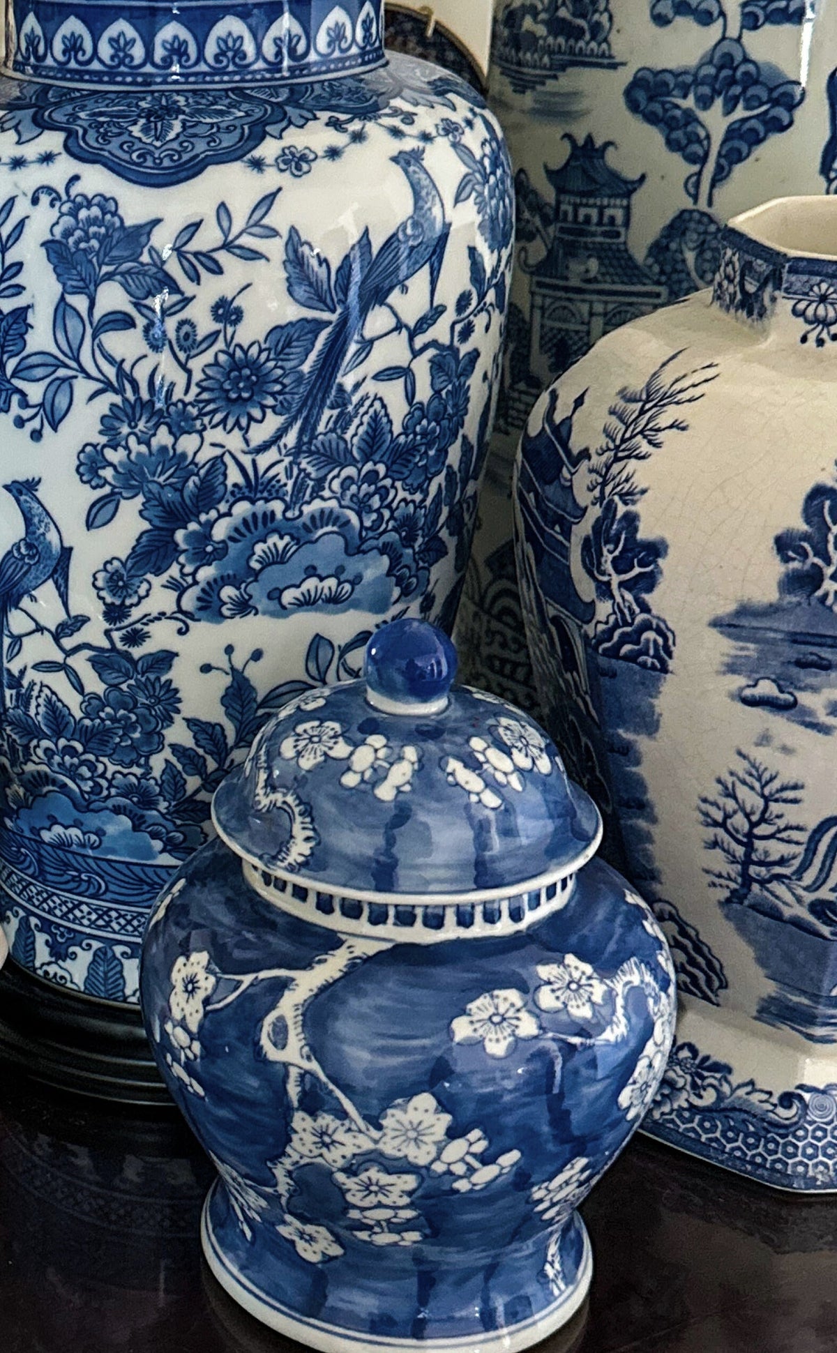 European antiques and heritage interiors — a collection of 19th-century French and English pieces styled with linen, wood, and ceramic vessels, reflecting the refined British countryside aesthetic.