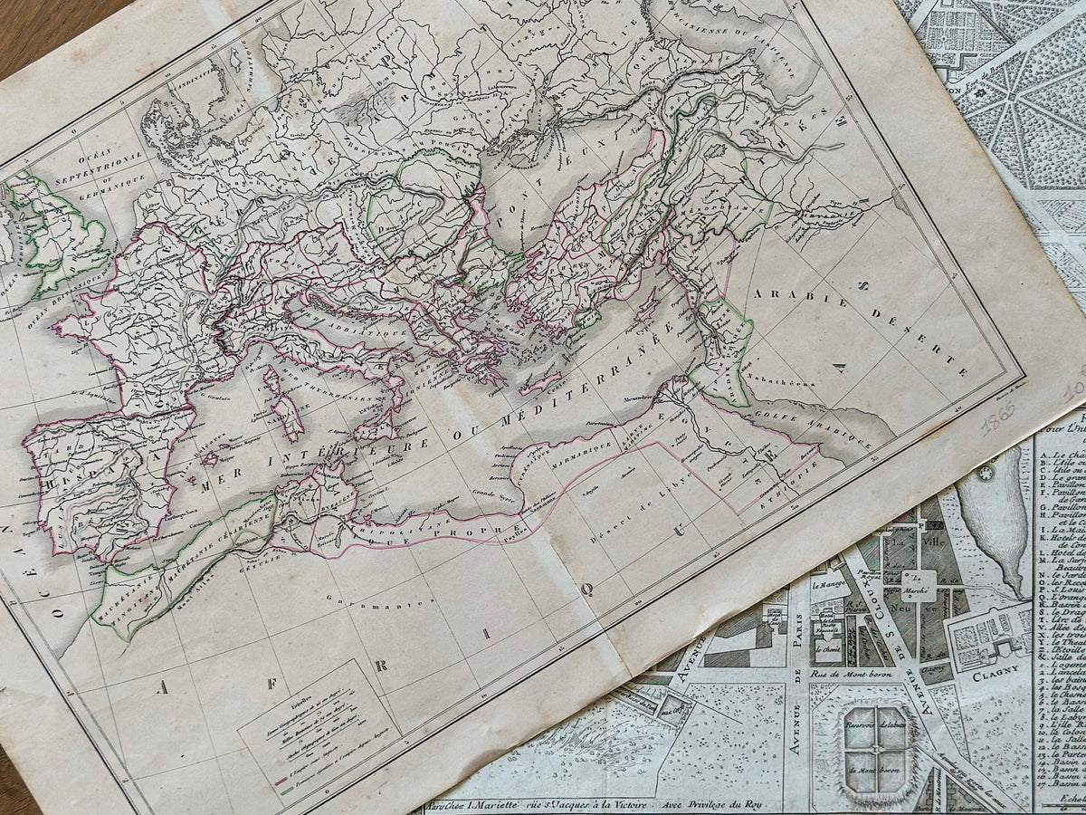 19th-century European map with hand-tinted borders displayed over aged parchment—illustrating old-world craftsmanship and historical cartography.