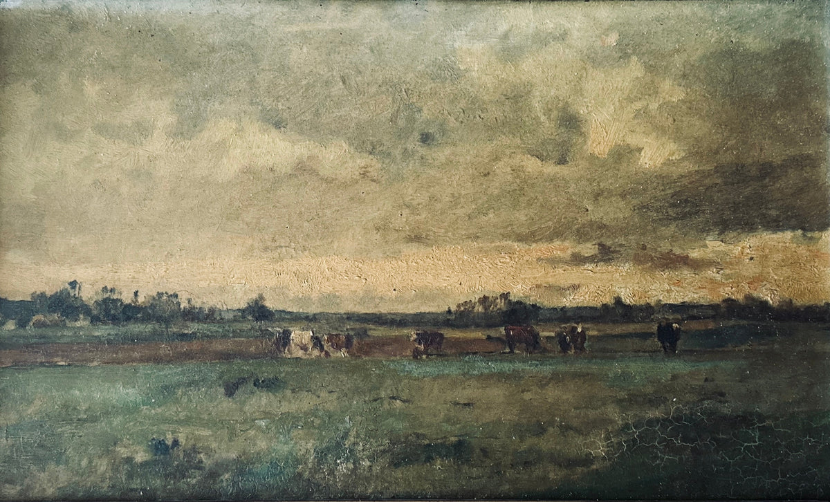 Antique gilt frame with 19th-century British landscape oil painting on a dark table.